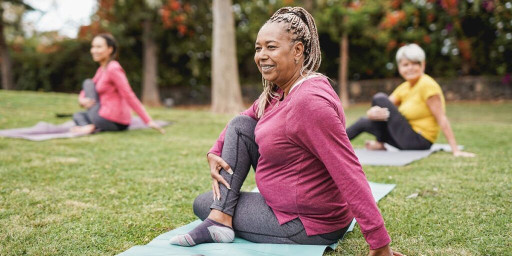 A woman and her friends doing a yoga class outdoors at the dementia care in Thousand Oaks
